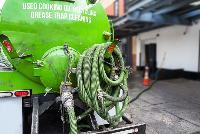 grease trap pumping truck in action in Bayport, NY